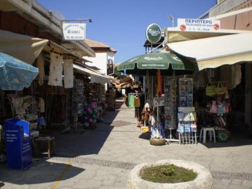 a street with a market with a bunch of shops at The Olympians Villas in Polis Chrysochous