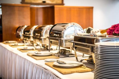 a long table with plates and dishes on it at VitalHotel Ascona in Bad Bevensen