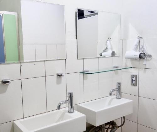 a bathroom with two sinks and a mirror at Old Man Captain in Tainan