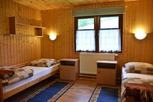 two beds in a room with a window at Camping Baltic in Kołobrzeg