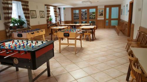 a room filled with tables and counters with chessboards at Casa Santa Maria in Folgaria