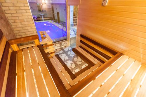 an overhead view of a pool with a wooden bench at Salut Hotel Almaty in Almaty