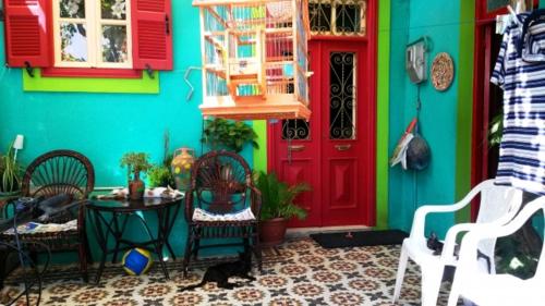 a colorful house with a table and a red door at Hotel Kalithea in Kallithea Rhodes