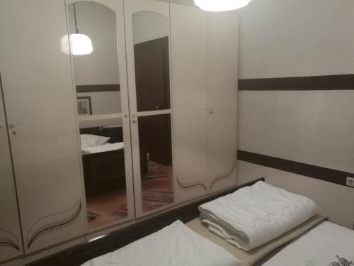a room with a mirror and a bed and a bed sidx sidx sidx at Odvojak Apartments in Crikvenica