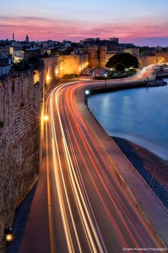 a night view of a city with lights on a highway at Hotel Kalithea in Kallithea Rhodes