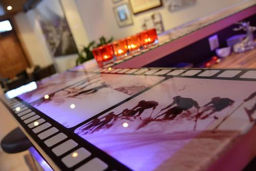 a glass table with a picture of birds on it at "Quality Hosts Arlberg Hotel Garni Mössmer" in Sankt Anton am Arlberg