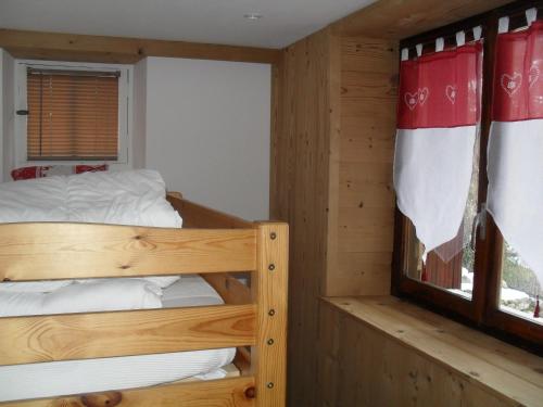 a bedroom with two bunk beds and a window at Les Clarines in Saint-Gervais-les-Bains