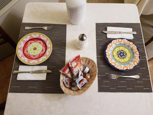 a table with plates of food and utensils at Hotel Ponte San Vittorino in Assisi