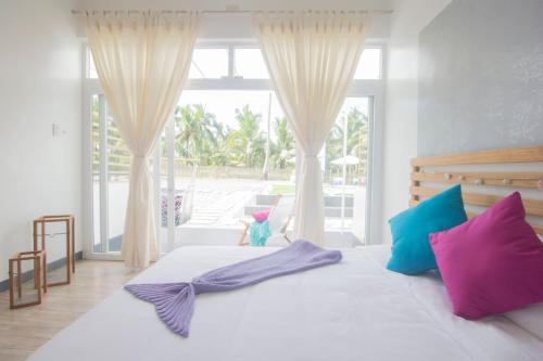 Ein Bett oder Betten in einem Zimmer der Unterkunft L'Sirene Boutique Resort