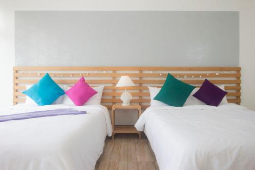 two beds sitting next to each other in a room at L'Sirene Boutique Resort in Baler