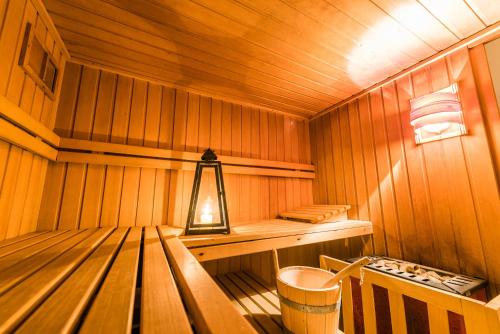 a small wooden sauna with a lantern in it at Sporthotel Villa Stella in Nago-Torbole