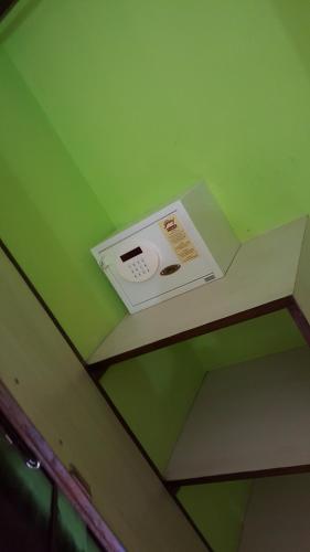 a microwave on the ceiling of a room at John's Highland Comfort (Guest House) in Majorda