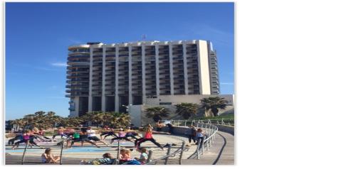 a group of people doing exercises in a pool at Raphael Apartments in Herzelia 