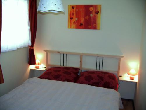 リュッベンにあるFerienwohnung-gurranのベッドルーム1室(ベッド1台、2つのテーブルに照明付)