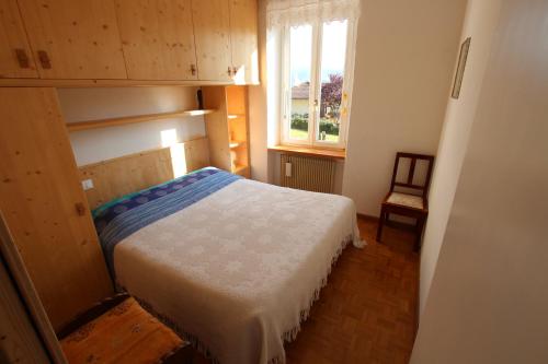 a small bedroom with a bed and a window at Casa Artz in Brez