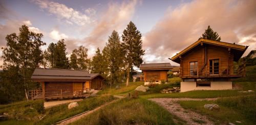 a cabin in the woods with a path leading to it at Les Mazots de la Source & Spa in Vercorin