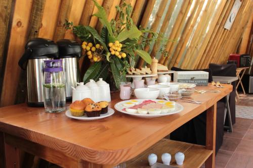 a wooden table with plates of food on it at Organica Lodge Hotel Boutique in Vicuña