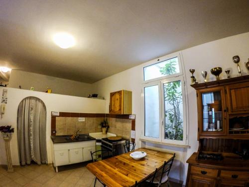 a kitchen with a wooden table and a window at Le Cascatelle in Cerveteri