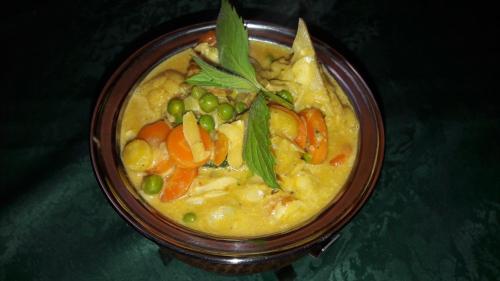 a bowl of soup with peas and carrots and greens at HOTEL YOGA JASMIN ehemals Hotel Eberhardt-Burghardt in Badenweiler