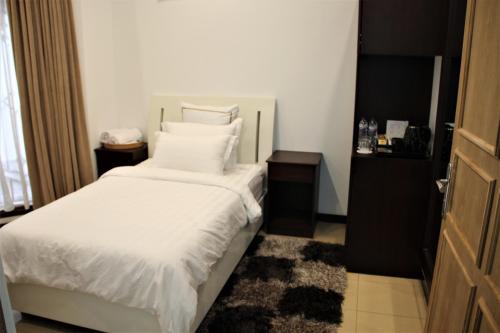 Кровать или кровати в номере Alsalam Syariah Guesthouse