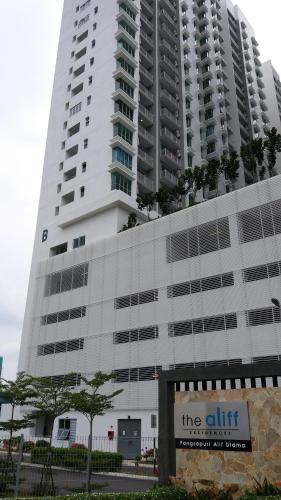 a tall white building with a sign in front of it at The Aliff Residences in Johor Bahru