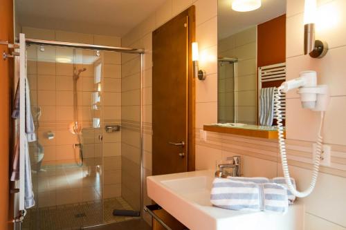 a bathroom with a sink and a shower at Chasa Miramont in Samnaun