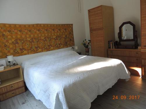 a bedroom with a white bed and a mirror at Appartamento Al numero 11 in Como