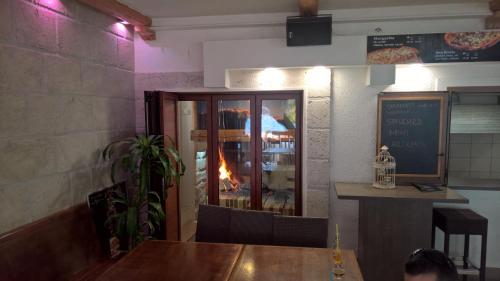 a restaurant with a table and a fire in the window at Apartment Anastazija in Omiš