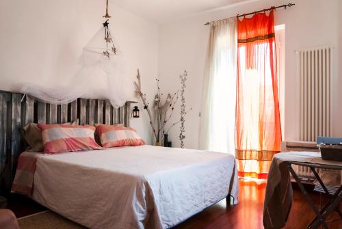 a bedroom with a bed and a window and a table at Vistazzurra B&B in Ancona