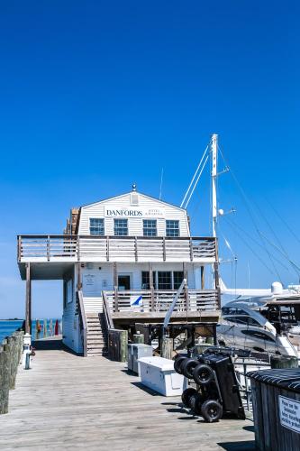 a boat is docked at a dock at Danfords Hotel & Marina in Port Jefferson Station