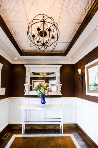 a dining room with a white table and a vase of flowers at Danfords Hotel & Marina in Port Jefferson Station