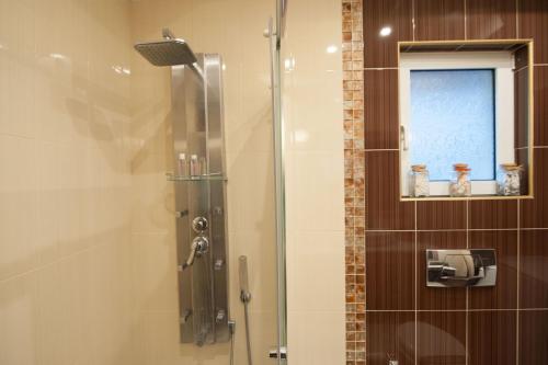 a shower with a glass door in a bathroom at Villa Amfimala in Georgioupolis