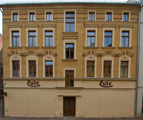 a large brick building with the name ule on it at Ferienwohnungen EULE in Lutherstadt Wittenberg