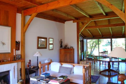 a living room with a white couch and a fireplace at Four Fields Farm in The Crags
