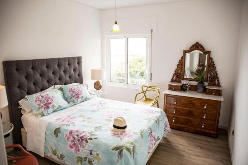 a bedroom with a large bed with a hat on it at Apartment Serrão in Funchal
