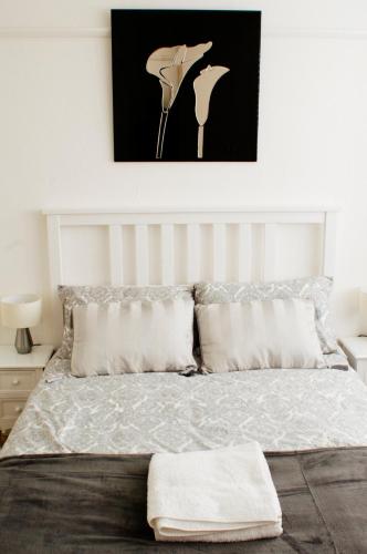 a bedroom with a bed with a picture on the wall at Grenville in London