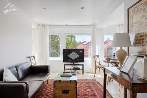 a living room with a couch and a table at Seven Rivers Luxury Apartment in Lisbon
