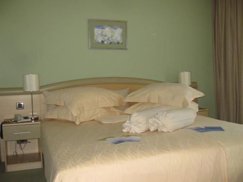 a bedroom with a bed with towels on it at Hotel Kimen in Cres