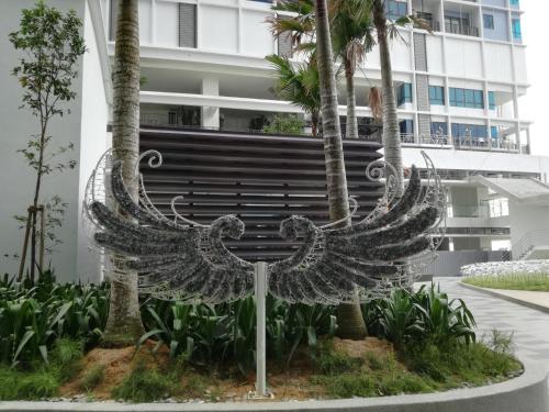 a metal sculpture of two birds in front of a building at i-city i-soho in Shah Alam