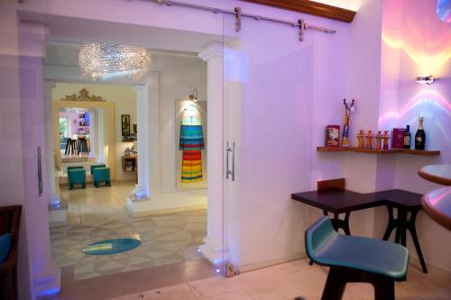 a room with a table and chairs and a hallway at Piccolo Grand Hotel in Pizzo