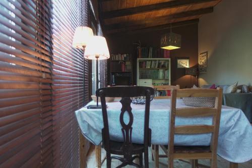 a dining room with a table and two chairs at Las Horas Perdidas in Manzanares el Real