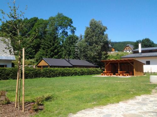 a large yard with a pavilion in the background at Chata Alexandra in Malá Morávka