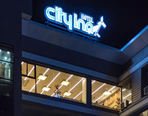 a sign on the side of a store at Hotel City Inn in Gandhinagar