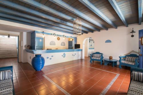 a living room with a table and a blue counter at Kerame Studios & Apartments in Évdhilos