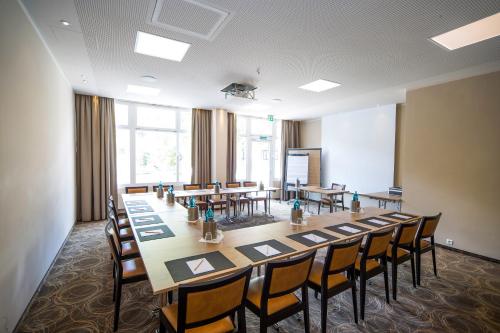 a large conference room with a long table and chairs at Caravelle Hotel im Park in Bad Kreuznach
