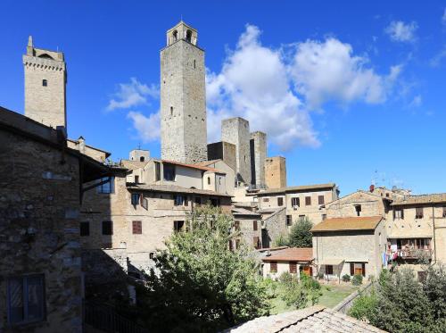 a city with two towers on top of buildings at Fabio Apartments San Gimignano in San Gimignano