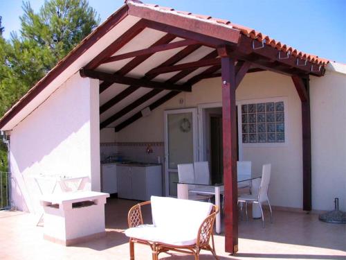 a pavilion with a table and chairs on a patio at Villa Ujoli in Splitska