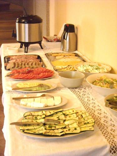 a buffet with many different types of food on a table at Leśne Berdo Przysłup in Cisna