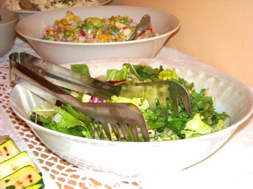 a salad in a bowl with a fork in it at Leśne Berdo Przysłup in Cisna