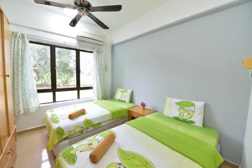 a bedroom with two beds and a window at Kijal Family Apartment in Kijal